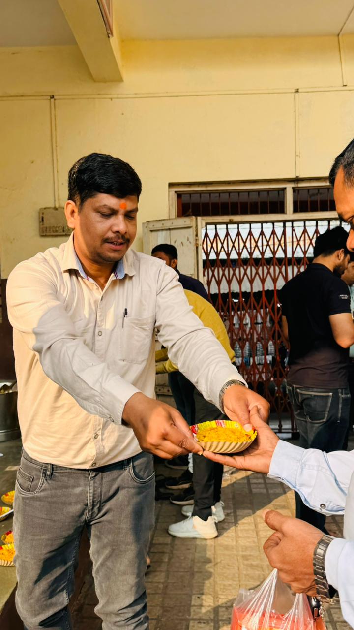 Handing a plate to a visiting devotee